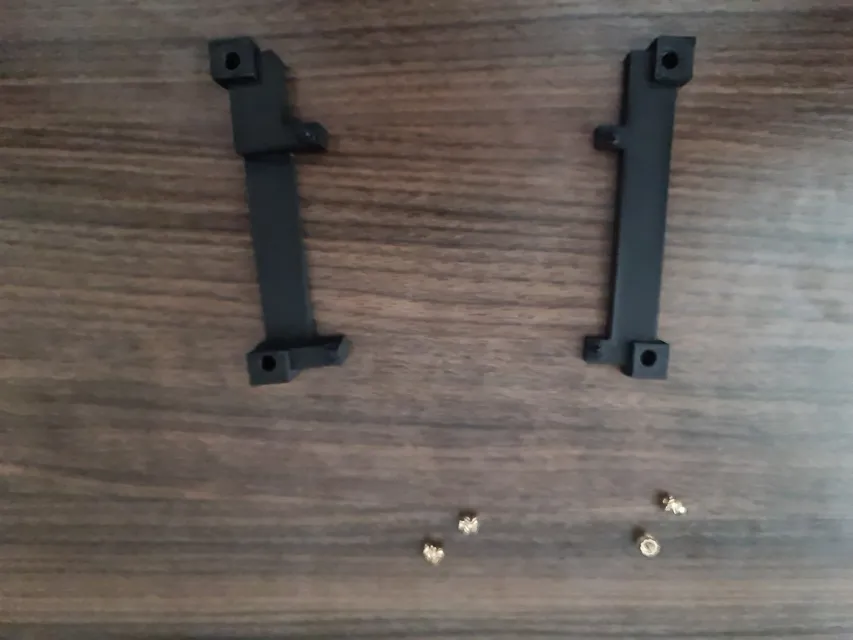 The printed brackets with the brass inserts.