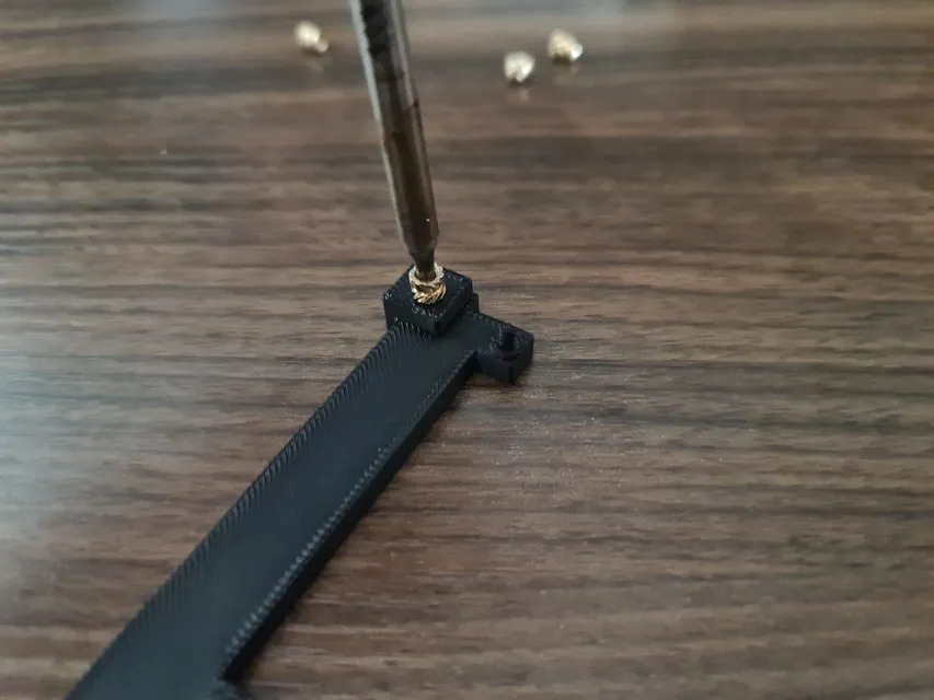 The soldering iron inserted into the brass insert.